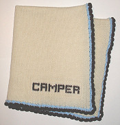 knitted baby blanket with blue and brown trim